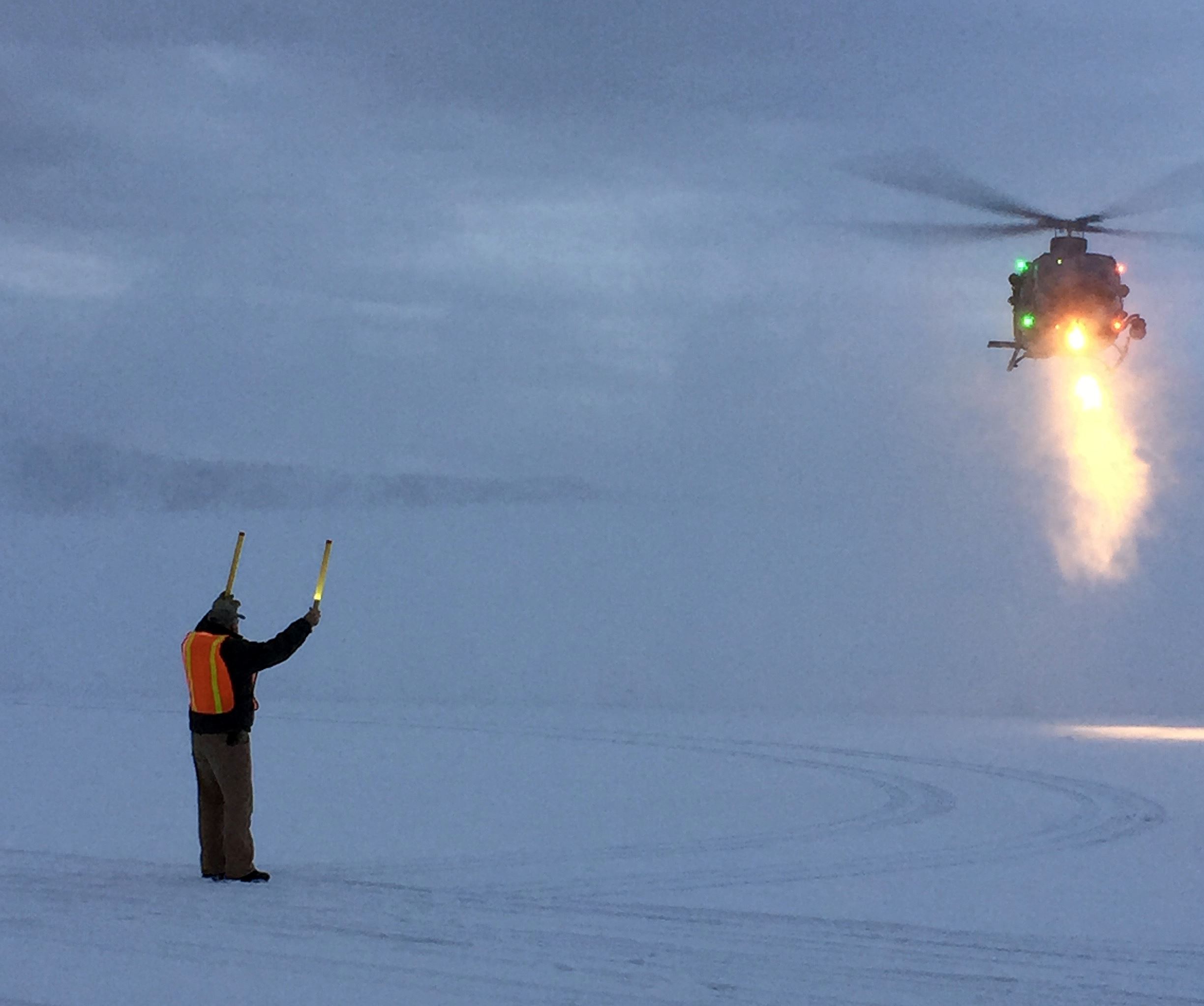 Crew Help Helicopter Land at KSBS