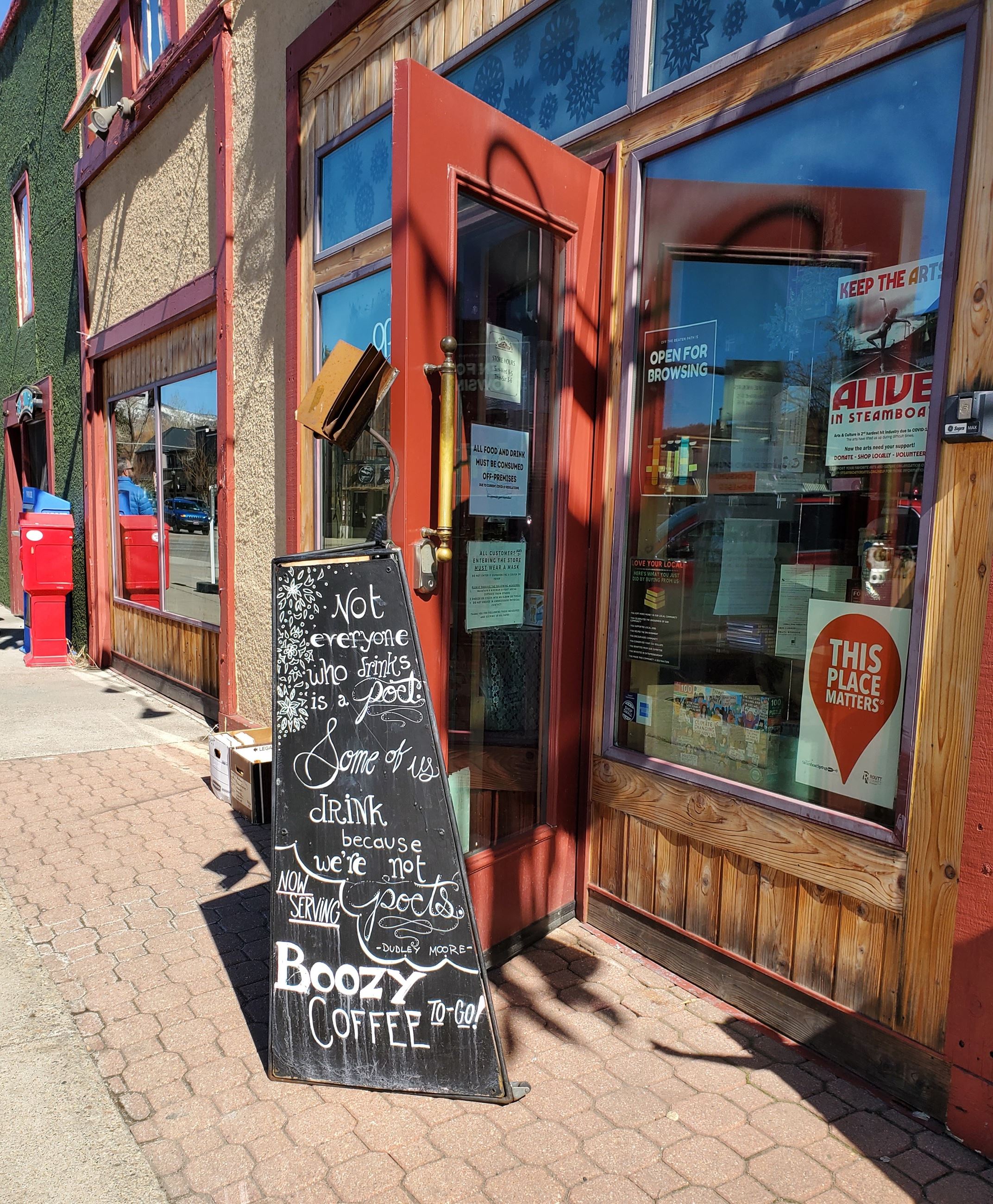 Cafe sign with menu in front of coffee shop